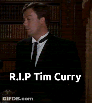 Man In Suit In Front Of Bookshelf R.I.P. Tim Curry GIF