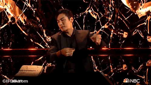 Man In Suit In Front Of Broken Glass Wall GIF