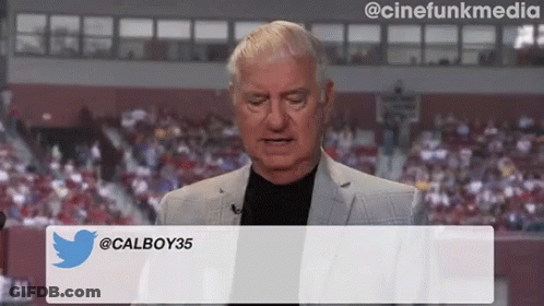 Man In Suit In Front Of Calboy35 Screen GIF