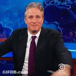Man In Suit In Front Of Comedy Studios GIF