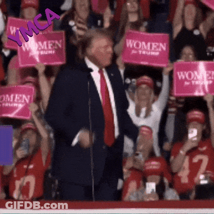 Man In Suit In Front Of Crowd Holding Pink Signs Saying Women GIF