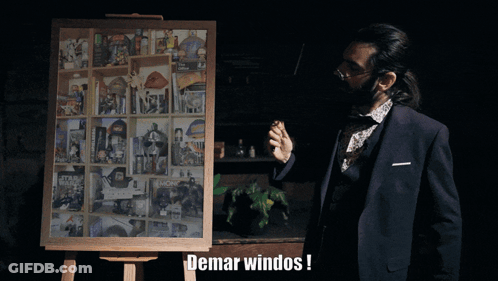 Man In Suit In Front Of Demar Windos Display Board GIF