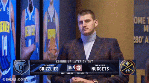 Man In Suit In Front Of Denver Nuggets Screen GIF