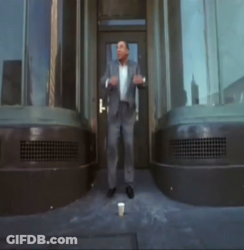 Man In Suit In Front Of Door GIF