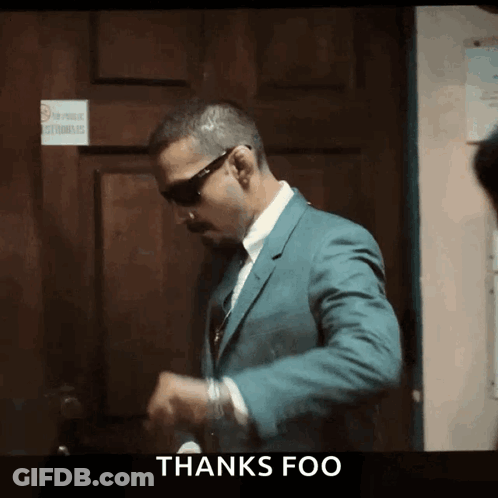 Man In Suit In Front Of Door Saying Thanks Foo GIF