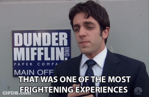 Man In Suit In Front Of Dunder Mifflin Sign GIF