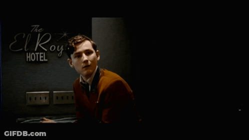 Man In Suit In Front Of El Royale Hotel Sign GIF