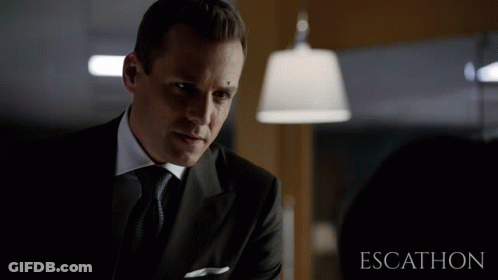 Man In Suit In Front Of Escalhon Sign GIF