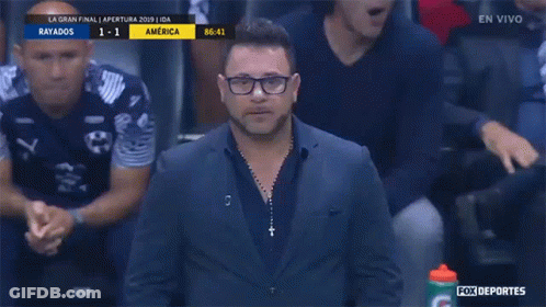 Man In Suit In Front Of Fox Deportes Advertisement GIF