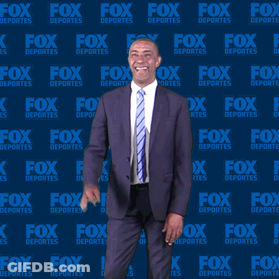Man In Suit In Front Of Fox Deportes Background GIF