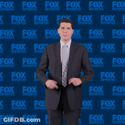 Man In Suit In Front Of Fox Deportes Background GIF