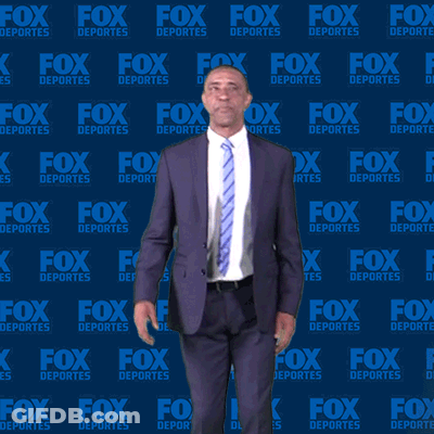 Man In Suit In Front Of Fox Deportes Wall GIF
