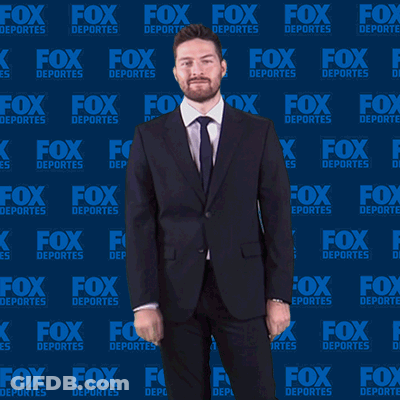Man In Suit In Front Of Fox Deportes Wall GIF