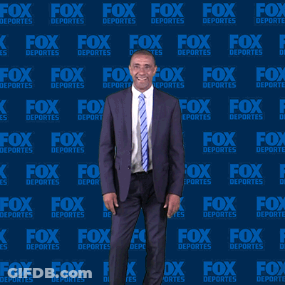 Man In Suit In Front Of Fox Deportes Wall GIF