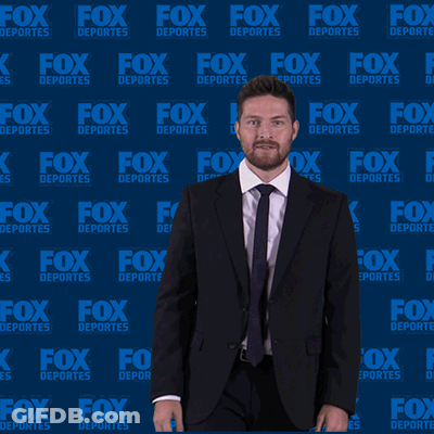 Man In Suit In Front Of Fox Deportes Wall GIF