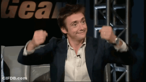 Man In Suit In Front Of Gear Sign GIF