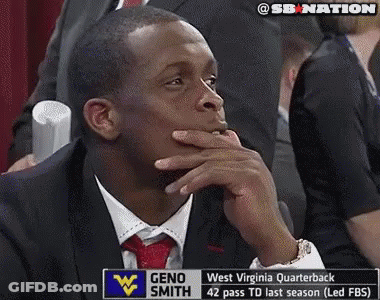 Man In Suit In Front Of Geno Smith Sign GIF