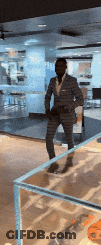 Man In Suit In Front Of Glass Wall GIF
