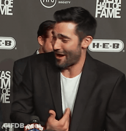 Man In Suit In Front Of Hall Of Fame Wall GIF
