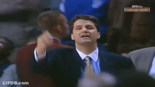 Man In Suit In Front Of Hardwood Classics Screen GIF
