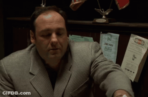 Man In Suit In Front Of Menu GIF