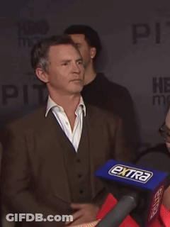 Man In Suit In Front Of Microphone Saying Extra GIF