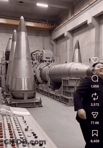 Man In Suit In Front Of Missiles GIF