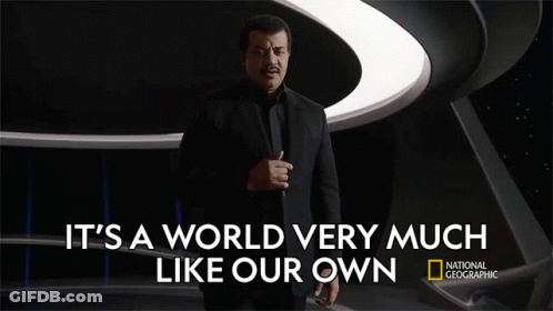 Man In Suit In Front Of National Geographic Sign GIF