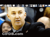Man In Suit In Front Of NBA Screen GIF