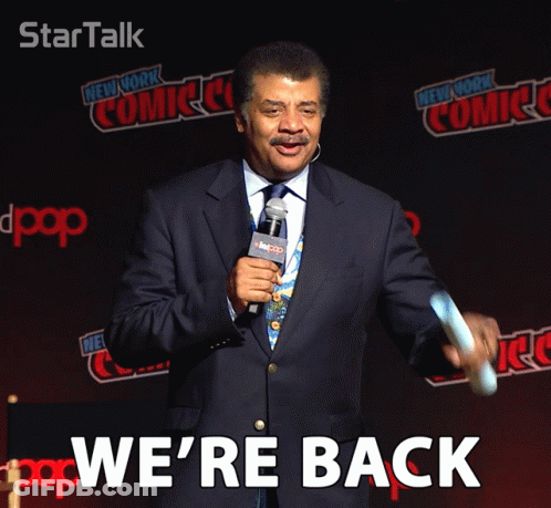 Man In Suit In Front Of New York Comic Con Wall GIF