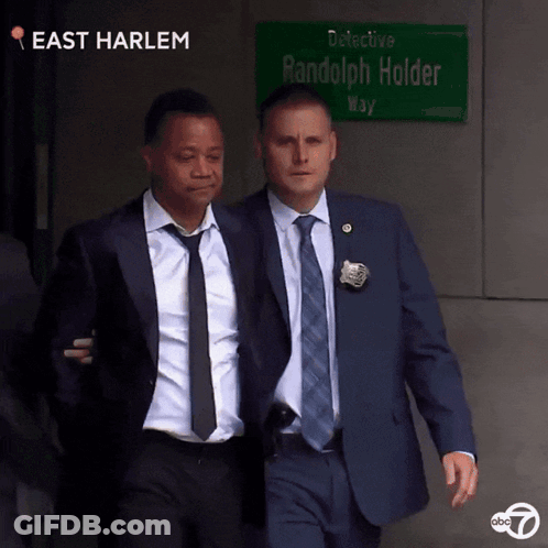 Man In Suit In Front Of Police Lineup 0 To 60 GIF