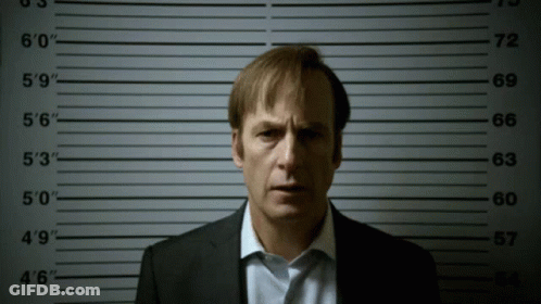 Man In Suit In Front Of Police Lineup Numbers 0 To 60 GIF