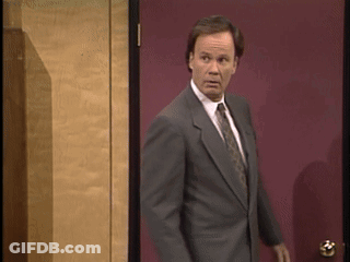 Man In Suit In Front Of Red Door GIF