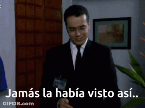 Man In Suit In Front Of Sign Saying Jamas La Habia Visto Asi GIF