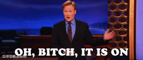 Man In Suit In Front Of Sign Saying Oh Bitch It Is On GIF
