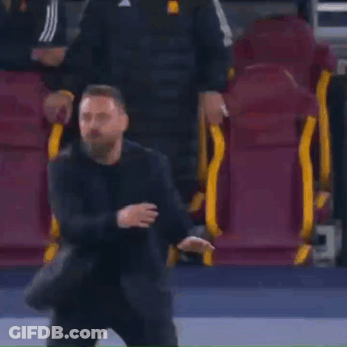 Man In Suit In Front Of Soccer Seats GIF