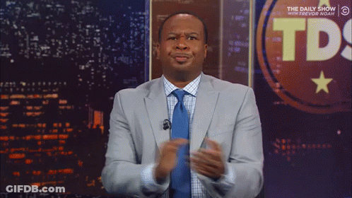 Man In Suit In Front Of TDS Sign GIF