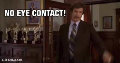 Man In Suit In Front Of Trophies Saying No Eye Contact GIF