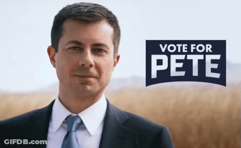 Man In Suit In Front Of Vote For Pete Sign GIF