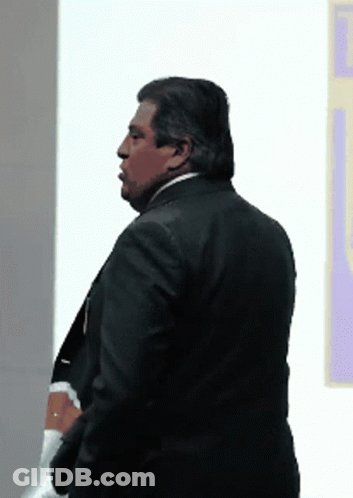 Man In Suit In Front Of Wall GIF