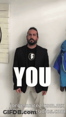 Man In Suit In Front Of Wall Saying You GIF