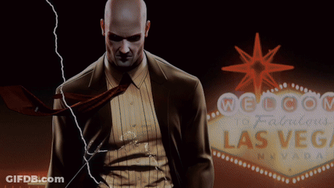 Man In Suit In Front Of Welcome To Las Vegas Sign GIF