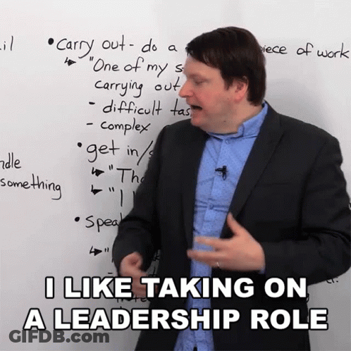 Man In Suit In Front Of Whiteboard Saying I Like Taking On A Leadership Role GIF