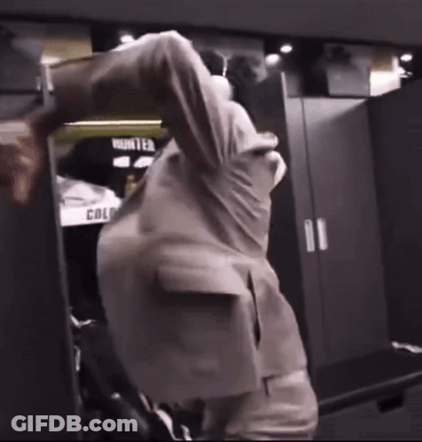 Man In Suit In Locker Room With Word Hunter GIF