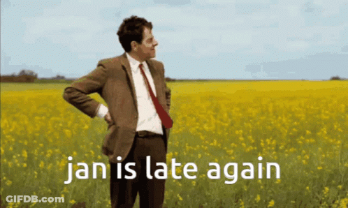 Man In Suit In Yellow Flowers Saying Jan Is Late Again GIF