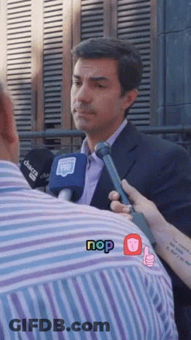 Man In Suit Interviewed By Person With Nop Sticker GIF