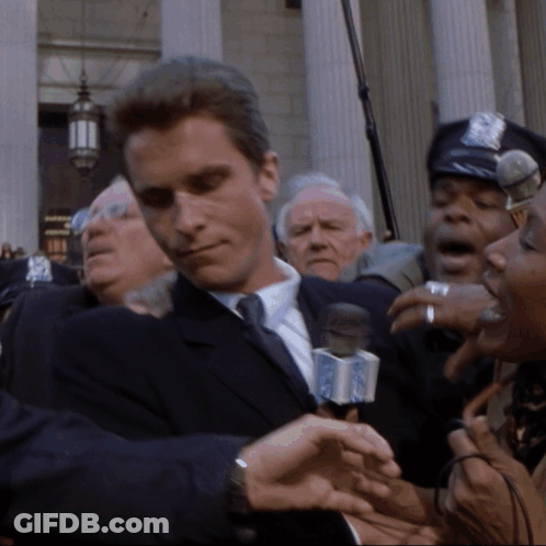 Man In Suit Interviewed By Woman With NBC Microphone GIF