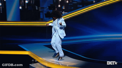 Man In Suit Jumping On Stage With Bet Background GIF