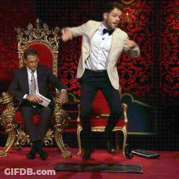 Man In Suit Jumping While Another Sits On Throne GIF