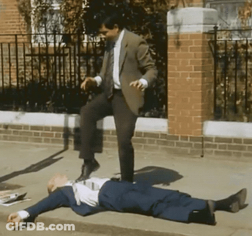 Man In Suit Kicking Another Man GIF
